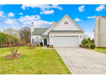 White home with a well-kept lawn, attached garage, and a charming entrance at 13705 Queenswater Ln, Charlotte, NC 28273