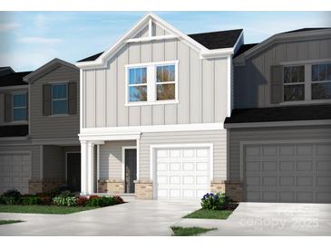 Charming home with a two-car garage, grey siding, and well-manicured landscaping at 1732 Braemar Village Dr, Monroe, NC 28110