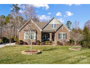 Charming brick home with a well-manicured lawn and inviting curb appeal at 215 Wesley Manor Dr, Matthews, NC 28104
