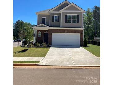 Two-story home featuring a two-car garage, brick and siding, and manicured lawn at 2202 Catawba Trace Dr, Catawba, NC 28609