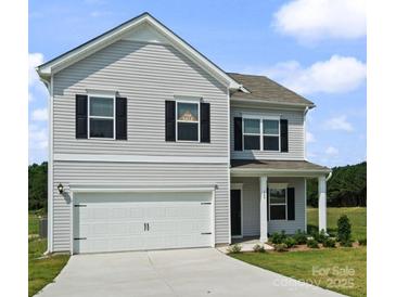 Charming two-story home features a two-car garage and inviting front porch at 2223 Catawba Trace Dr, Catawba, NC 28609