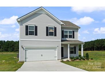 Charming two-story home featuring a two-car garage, classic shutters, and a well-manicured lawn, inviting curb appeal at 2223 Catawba Trace Dr, Catawba, NC 28609