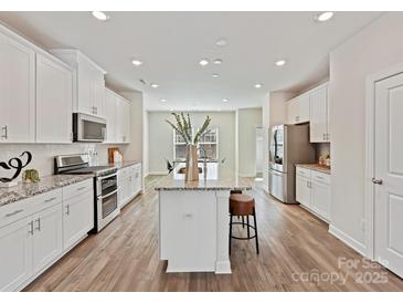 Modern kitchen featuring a large island, stainless steel appliances, and ample cabinet space at 2610 Greenmarket Dr, Charlotte, NC 28217