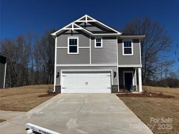 Charming two-story home featuring a gray exterior, white garage door, and well-manicured lawn at 313 Alden Ct, Shelby, NC 28152