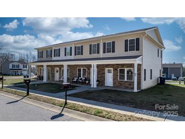 Inviting townhouse with charming stone accents, cozy porch seating, and well-maintained landscaping at 3931 Newhall Nw Dr, Hickory, NC 28601