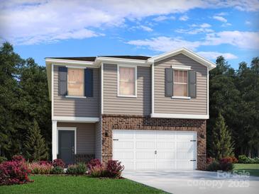 Two-story home featuring gray siding, brick accents, and a two-car garage at 5013 Poplin Vly, Cherryville, NC 28021