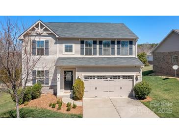 Charming two-story home with a well-manicured lawn and a two-car garage at 7217 Kenyon Dr, Denver, NC 28037