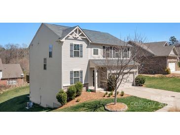A charming two-story home with vinyl siding and a well-maintained front yard at 7217 Kenyon Dr, Denver, NC 28037