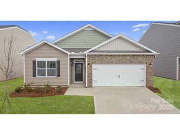 Charming single-Gathering home with brick accents, a two-car garage, and a well-manicured front lawn at 1344 Secrest Commons Ct, Monroe, NC 28112