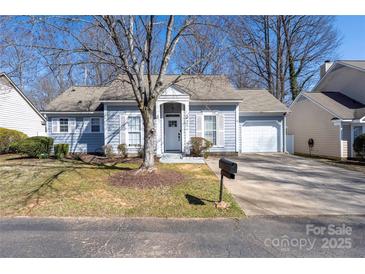 Charming single-story home with a manicured lawn and attached garage at 5616 Ebley Ln, Charlotte, NC 28227