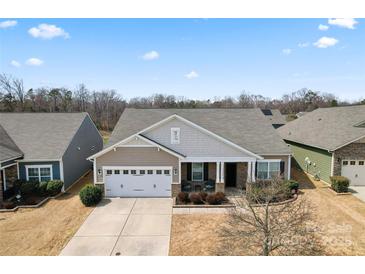 Charming single-story home with a covered front porch and a two-car garage in a desirable neighborhood at 11124 Chapeclane Rd, Charlotte, NC 28278
