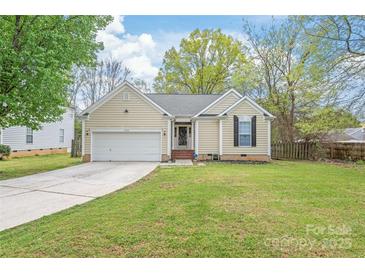Charming single-story home featuring a well-manicured lawn and an attached two-car garage at 11404 Larix Dr, Charlotte, NC 28273