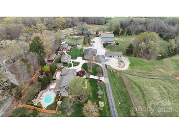 Expansive aerial view of an estate featuring multiple buildings, a pool, and picturesque landscaping at 1620 London Rd, Mooresville, NC 28115