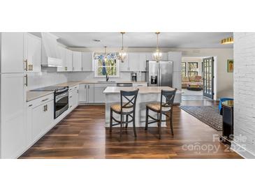 Bright, modern kitchen with white cabinets, stainless appliances, and a breakfast bar at 2052 10Th Street Nw Pl, Hickory, NC 28601