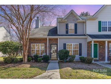 Charming townhome featuring a brick and siding exterior, complemented by lush landscaping and a welcoming walkway at 2249 Cigar Ct, Charlotte, NC 28273