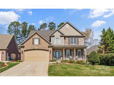 Charming two-story home featuring a blend of brick and stone, front porch, and manicured lawn at 3119 18Th Ne St, Hickory, NC 28601
