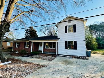Two-story home with brick and vinyl siding, front porch and driveway at 314 N Little Texas Rd, Kannapolis, NC 28083