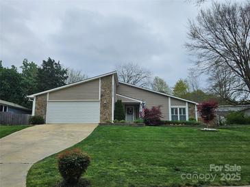 Charming ranch-style home with a two-car garage and beautifully manicured front lawn at 319 Vista Grande Cir, Charlotte, NC 28226