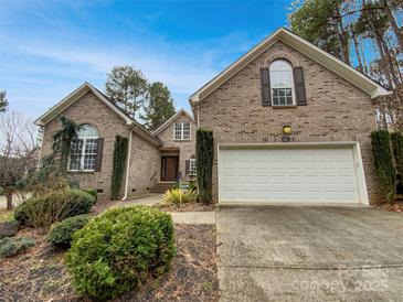 Charming brick home featuring a manicured front yard and a two-car garage at 3865 Granite St, Terrell, NC 28682