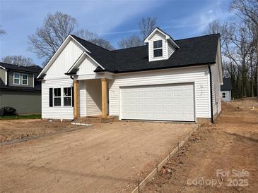 Charming new construction home featuring white siding, black roof, and an attached two-car garage at 402 Walker St, Kannapolis, NC 28081