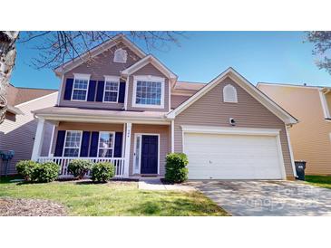 Charming two-story home features a two-car garage, well-maintained lawn, and dark shutters at 504 Galesburg Dr, Monroe, NC 28110