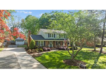 Charming two-story home with a landscaped front yard and brick accents at 6117 Brace Rd, Charlotte, NC 28211