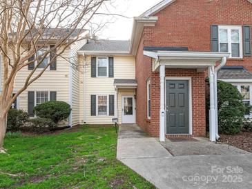 Charming townhouse exterior with a well-maintained lawn and inviting entrance at 9427 S Vicksburg Park Ct, Charlotte, NC 28210