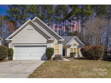 Charming single-Gathering home featuring a well-maintained front yard and a two-car attached garage at 12810 English Walnut Ln, Charlotte, NC 28215