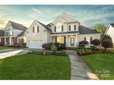 Charming two-story home with landscaped yard, attached garage, and inviting green front door at 1730 Townsend Ln, Rock Hill, SC 29730
