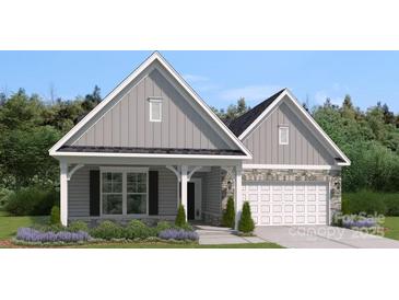 Charming single-Gathering home featuring a stone-accented facade, welcoming porch, and well-manicured landscaping at 2018 Mantle Ridge Dr, Indian Trail, NC 28079