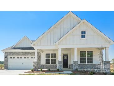 Charming home featuring a stone-accented garage and inviting front porch, blending modern and classic design at 228 Miramar Dr, York, SC 29745