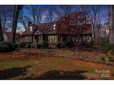 Charming Tudor-style home with brick accents and a well-manicured front yard at 2324 Chestnut Ln, Matthews, NC 28104