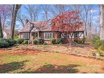 Charming Tudor-style home with brick accents and a well-manicured front yard at 2324 Chestnut Ln, Matthews, NC 28104