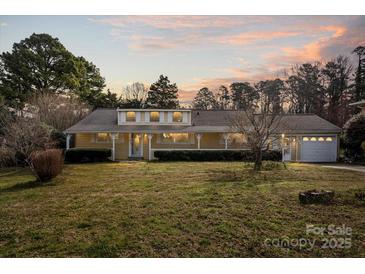 Charming single-story home with a spacious front yard, mature trees, and welcoming curb appeal at 468 Wilhelm Ne Pl, Concord, NC 28025