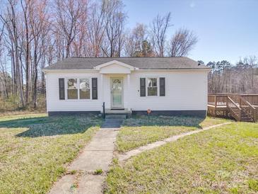 Charming single-story home with a white exterior, black shutters, a well-kept lawn, and a wooden deck at 5985 Bertie Ave, Salisbury, NC 28147