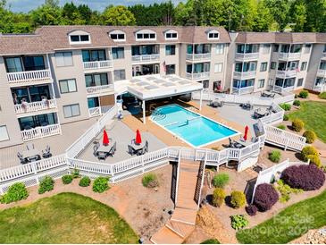 Beautiful in-ground pool on a manicured lawn at the condo community at 7831 Spinnaker Bay Dr # 106, Sherrills Ford, NC 28673