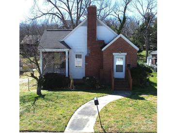 Charming home featuring a brick facade, a cozy porch, and a well-manicured lawn at 109 Oakland Ave, Chester, SC 29706