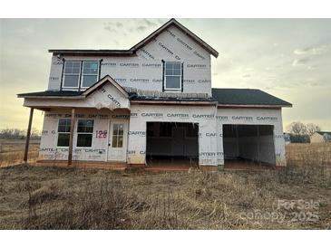 Unfinished two-story home showcasing its framing and design in a construction phase at 128 Peppervine Ln, Statesville, NC 28625
