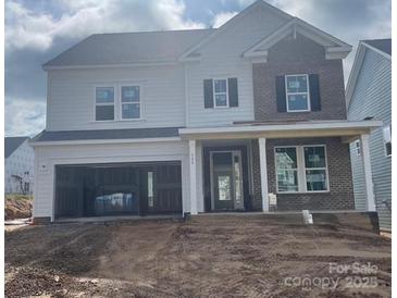 New two-story home featuring a brick facade, covered porch, and an attached two-car garage at 166 Holsworthy Dr, Mooresville, NC 28115