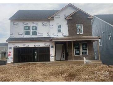 Two-story house with brick and siding exterior, covered front porch, and two car garage at 166 Holsworthy Dr, Mooresville, NC 28115