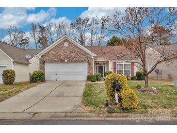 Charming single-story home with brick accents, a well-manicured lawn, and a two-car garage at 242 Tradition Way, Rock Hill, SC 29732