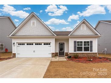 Charming single-Gathering home showcasing a white garage door and stone veneer accents at 4427 Allenby Pl, Monroe, NC 28110