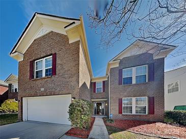 Charming brick home featuring a well-maintained yard and an attached two-car garage at 5513 Hammermill Dr, Harrisburg, NC 28075