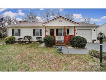 Charming single-story home featuring a metal roof, a cozy front porch, and an attached single car garage at 609 Ben Rich St, Dallas, NC 28034