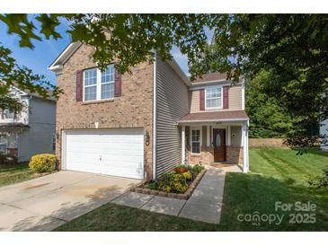 Charming two-story home featuring brick and neutral siding with a two-car garage and manicured landscaping at 6808 Wandering Creek Dr, Charlotte, NC 28216