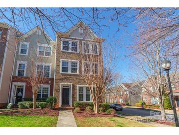 Charming brick townhome with lush green lawn and manicured landscaping, nestled in a beautiful neighborhood at 7147 Brighton Park Dr, Mint Hill, NC 28227