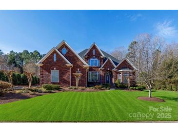 Inviting two-story brick home with manicured lawn and tasteful landscaping at 1038 Rolling Park Ln, Fort Mill, SC 29715