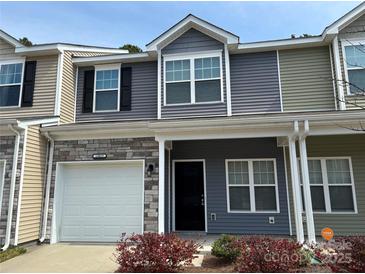 Charming multi-colored townhome featuring stone accents, a garage, and well-maintained landscaping at 13615 Browhill Ln, Charlotte, NC 28278