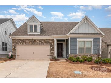 Charming home featuring a stone facade, two-car garage, and welcoming front porch at 19011 Dry Narrows Way, Charlotte, NC 28278