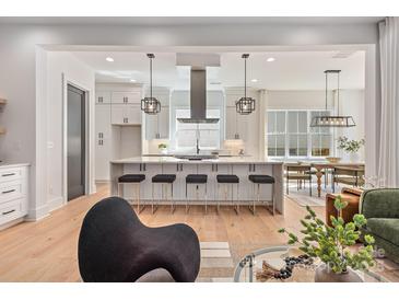 Bright, open kitchen with a large island, pendant lighting, and modern appliances at 3949 Plainview Rd, Charlotte, NC 28208